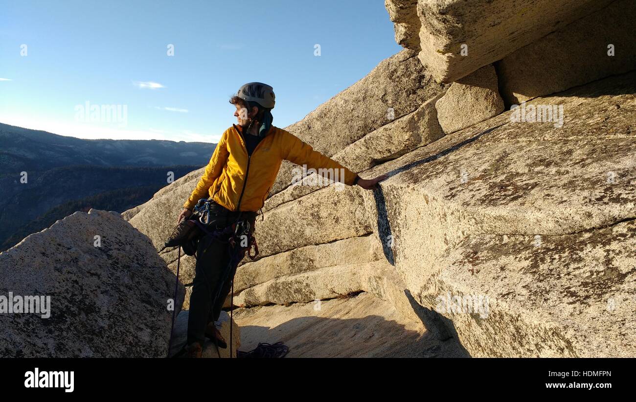 Climber taking in the view on Half Dome, Yosemite (end of Snike Dike route) Stock Photo