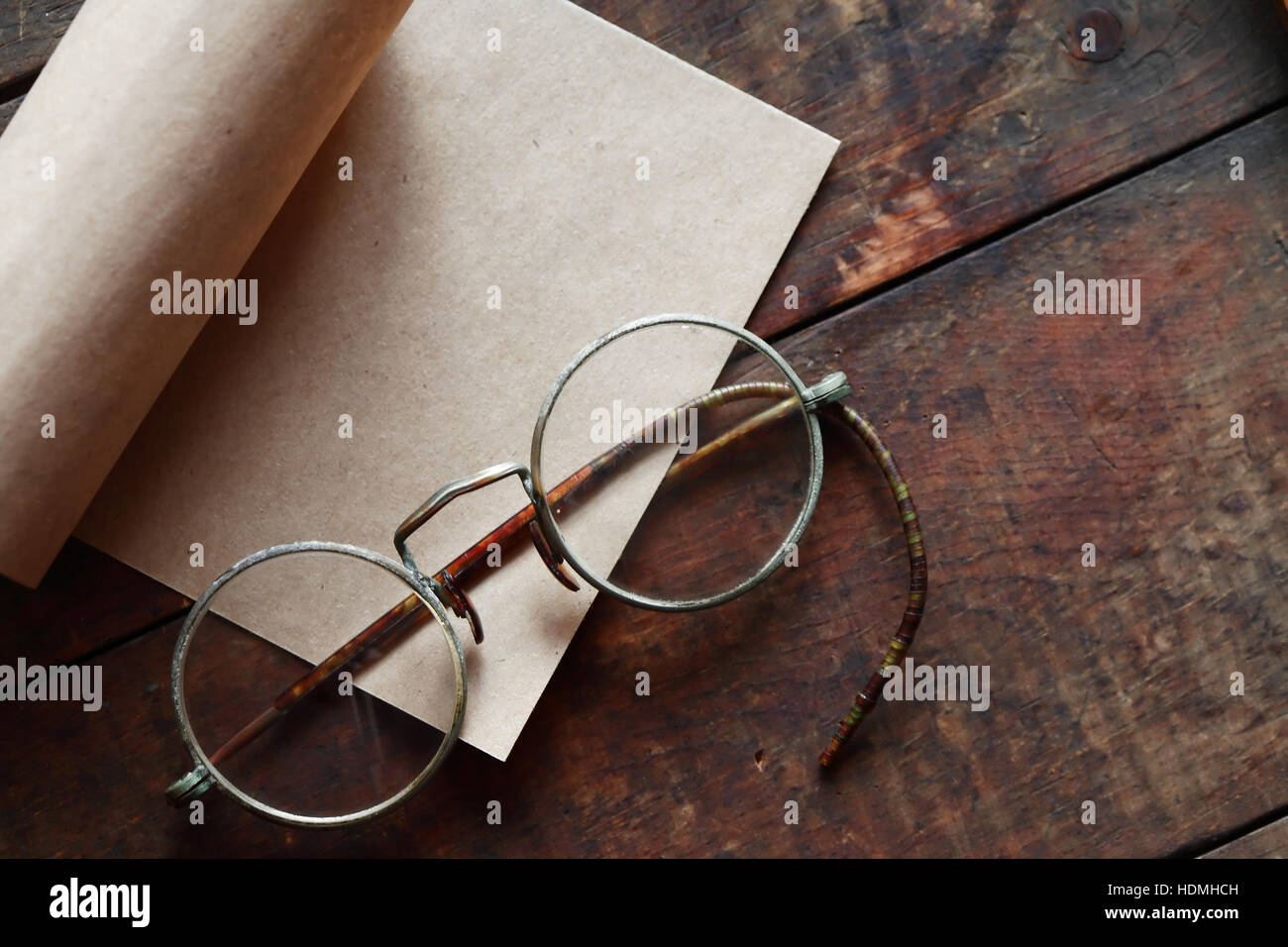 Paper and spectacles on nice old wooden background Stock Photo