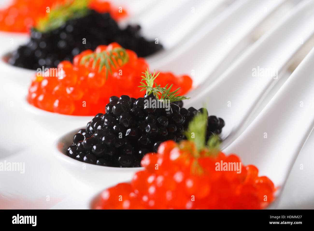 delicious red and black caviar fish close-up in white spoons on a plate.  horizontal Stock Photo - Alamy