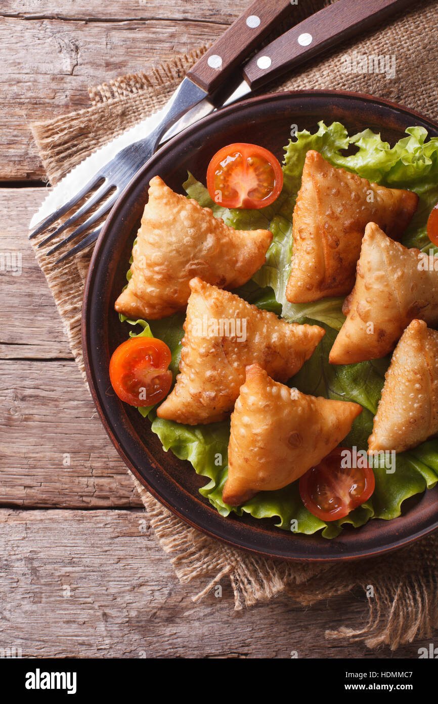 delicious pastry samosas on a plate close-up. vertical view above, rustic style Stock Photo