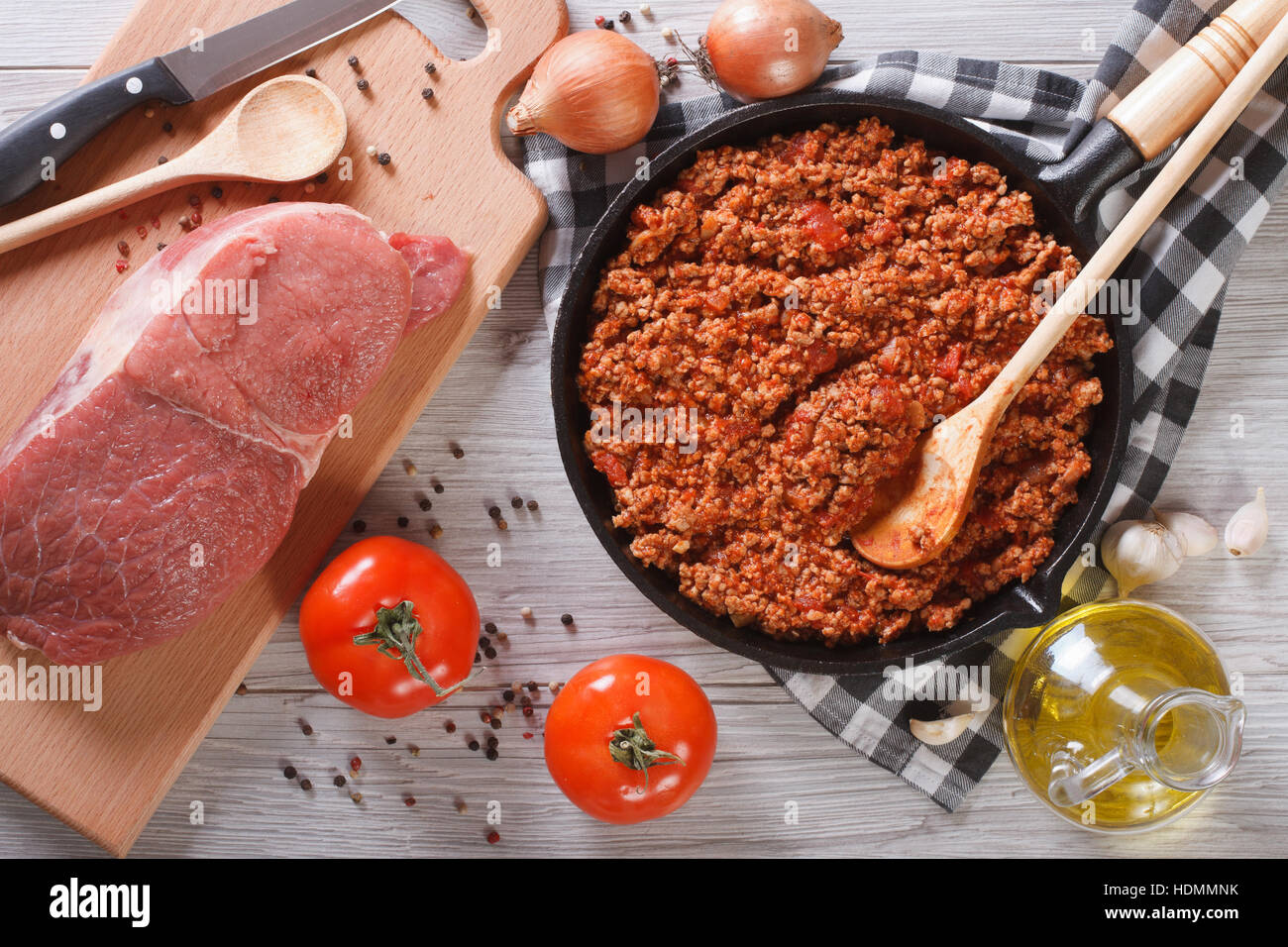 Bolognese sauce in a pan and ingredients on the table. horizontal view from above Stock Photo