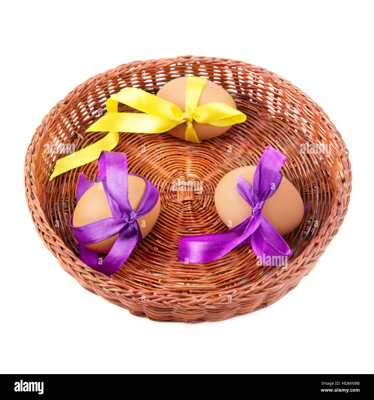 Easter eggs in a wicker basket isolation  on a white background Stock Photo