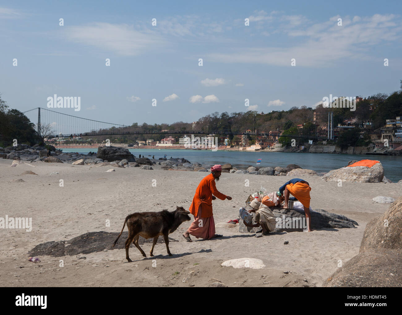 Two holy men resting on the river bank in Rishikesh, India Stock Photo
