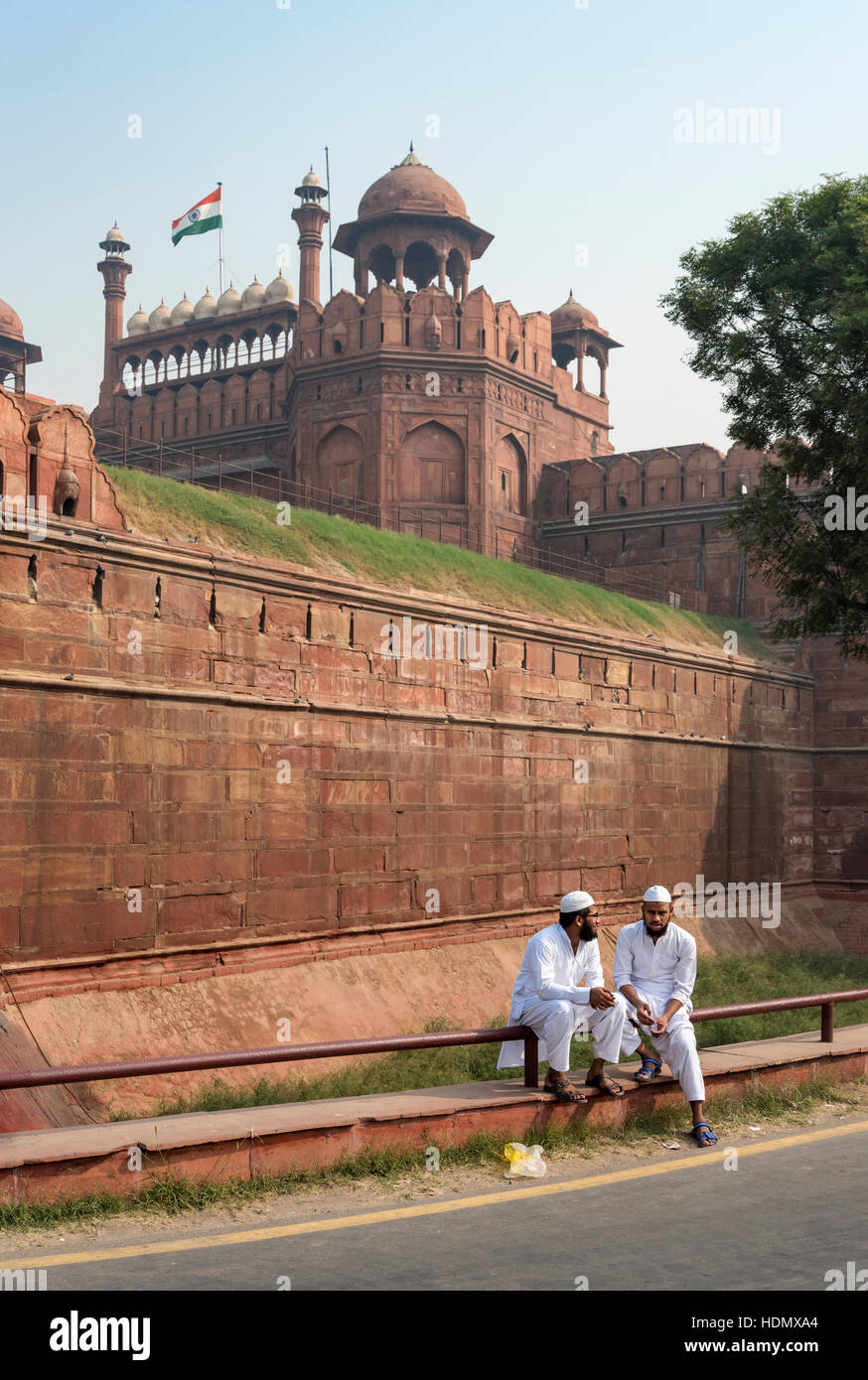 Two Indian Muslim men in traditional dress in front of walls of Red Fort, Delhi, India Stock Photo