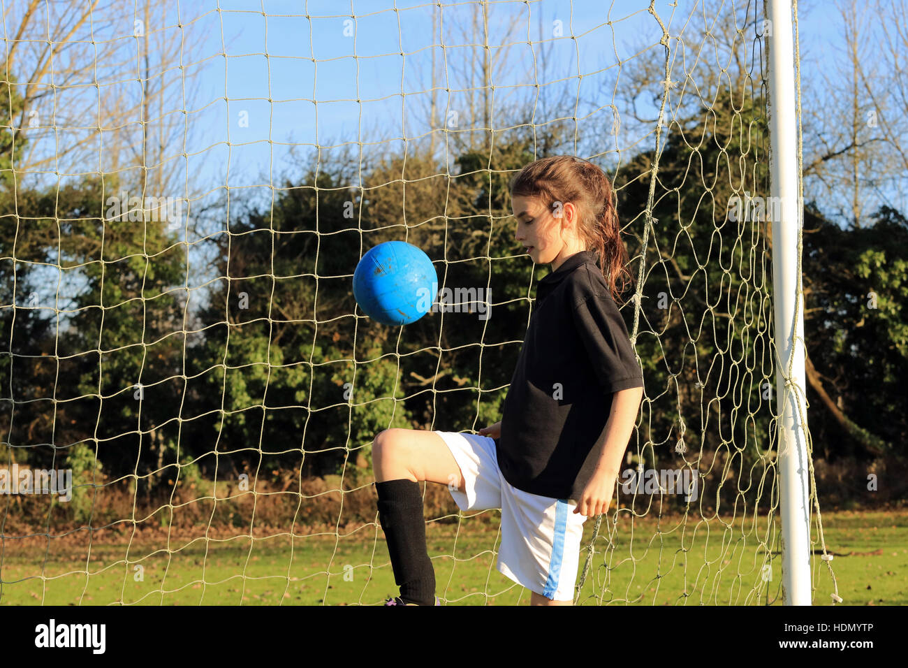 English school girl playing football Stock Photo