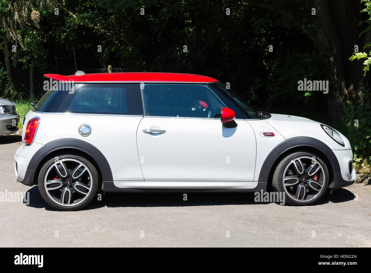 Red and white Mini (BMW) Cooper in parking area, Chobham, Surrey, England, United Kingdom Stock Photo