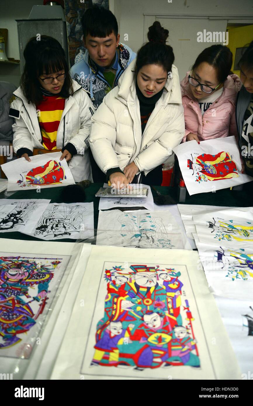 Liaocheng, Liaocheng, China. 12th Dec, 2016. Liaocheng, CHINA-December 12 2016: (EDITORIAL USE ONLY. CHINA OUT) .Students make woodblock prints at Liaocheng University in Liaocheng, east China's Shandong Province, December 12th, 2016. Woodblock printing is a technique for printing text, images or patterns used widely throughout East Asia and originating in China in antiquity as a method of printing on textiles and later paper. As a method of printing on cloth, the earliest surviving examples from China date to before 220 AD, and woodblock printing remained the most common East Asian metho Stock Photo