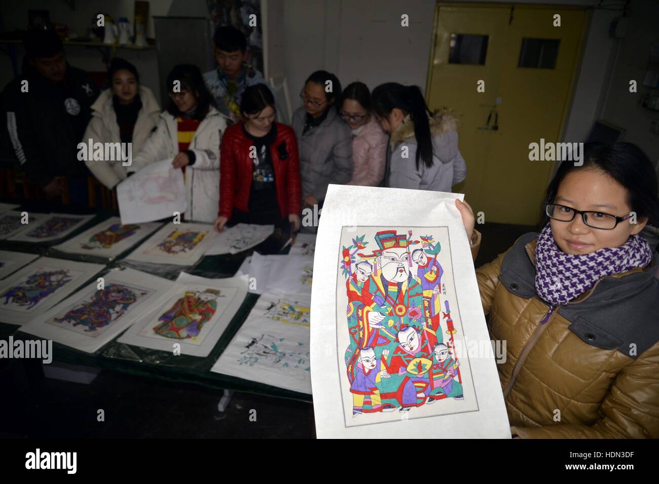 Liaocheng, Liaocheng, China. 12th Dec, 2016. Liaocheng, CHINA-December 12 2016: (EDITORIAL USE ONLY. CHINA OUT) .Students make woodblock prints at Liaocheng University in Liaocheng, east China's Shandong Province, December 12th, 2016. Woodblock printing is a technique for printing text, images or patterns used widely throughout East Asia and originating in China in antiquity as a method of printing on textiles and later paper. As a method of printing on cloth, the earliest surviving examples from China date to before 220 AD, and woodblock printing remained the most common East Asian metho Stock Photo