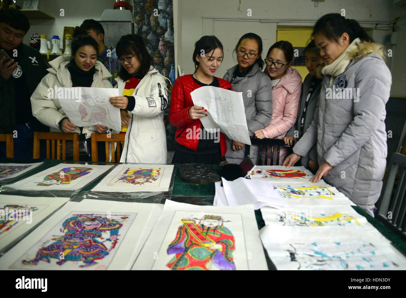 Liaocheng, Liaocheng, China. 12th Dec, 2016. Liaocheng, CHINA-December 12 2016: (EDITORIAL USE ONLY. CHINA OUT) .Students make woodblock prints at Liaocheng University in Liaocheng, east China's Shandong Province, December 12th, 2016. Woodblock printing is a technique for printing text, images or patterns used widely throughout East Asia and originating in China in antiquity as a method of printing on textiles and later paper. As a method of printing on cloth, the earliest surviving examples from China date to before 220 AD, and woodblock printing remained the most common East Asian metho Stock Photo