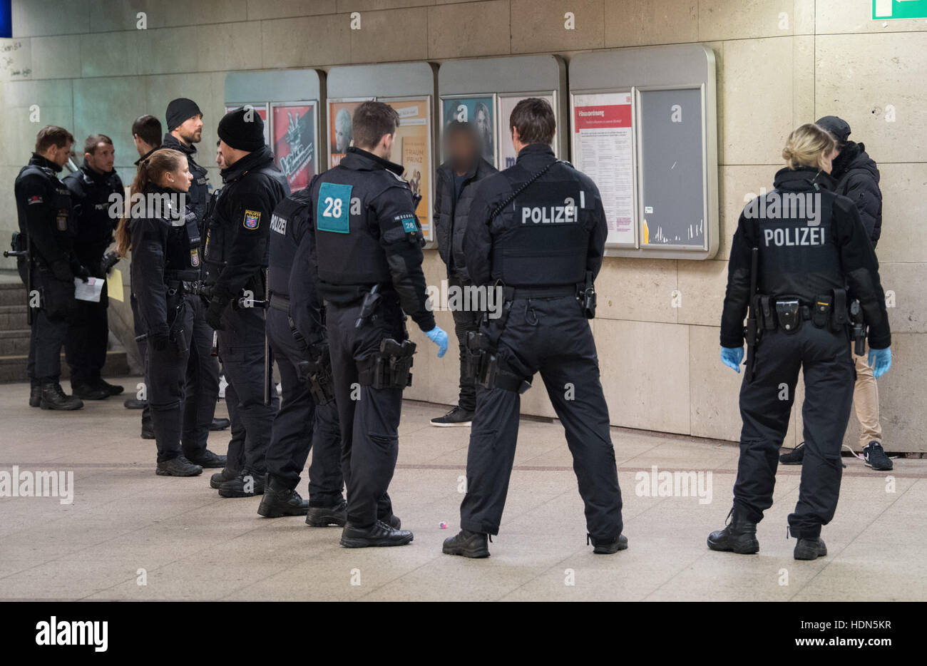 Frankfurt, Germany. 13th Dec, 2016. Police officers with a suspect in Frankfurt Central Station, Frankfurt am Main, Germany, 13 December 2016. The police has stepped up its patrols in the station in order to prevent crime and the drug trade. - ATTENTION EDITORS: The face of the suspect has been pixelated in order to preserve his/her anonymity - Photo: Boris Roessler/dpa © dpa picture alliance/Alamy Live News Stock Photo
