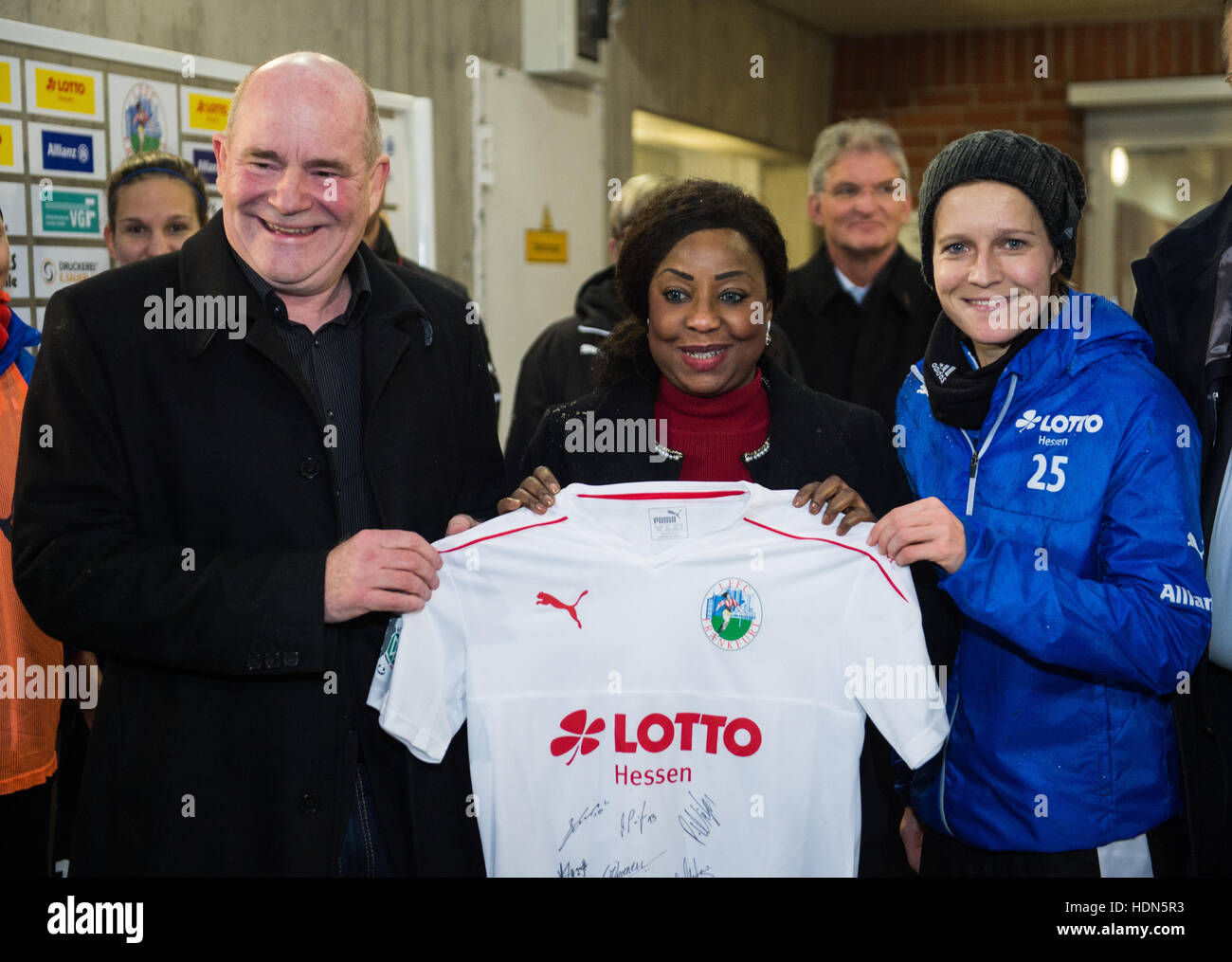 Frankfurt, Germany. 13th Dec, 2016. FIFA General Secretary Fatma Samoura (C), FCC Frankfurt coach Siegfried Dietrich and player Saskia Bartusiak with a jersey signed by the club's players in the Brentanobad Stadium in Frankfurt am Main, Germany, 13 December 2016. Samoura was invited by the German Soccer Association (DFB) to the first league women's soccer team FCC Frankfurt. © dpa picture alliance/Alamy Live News Stock Photo