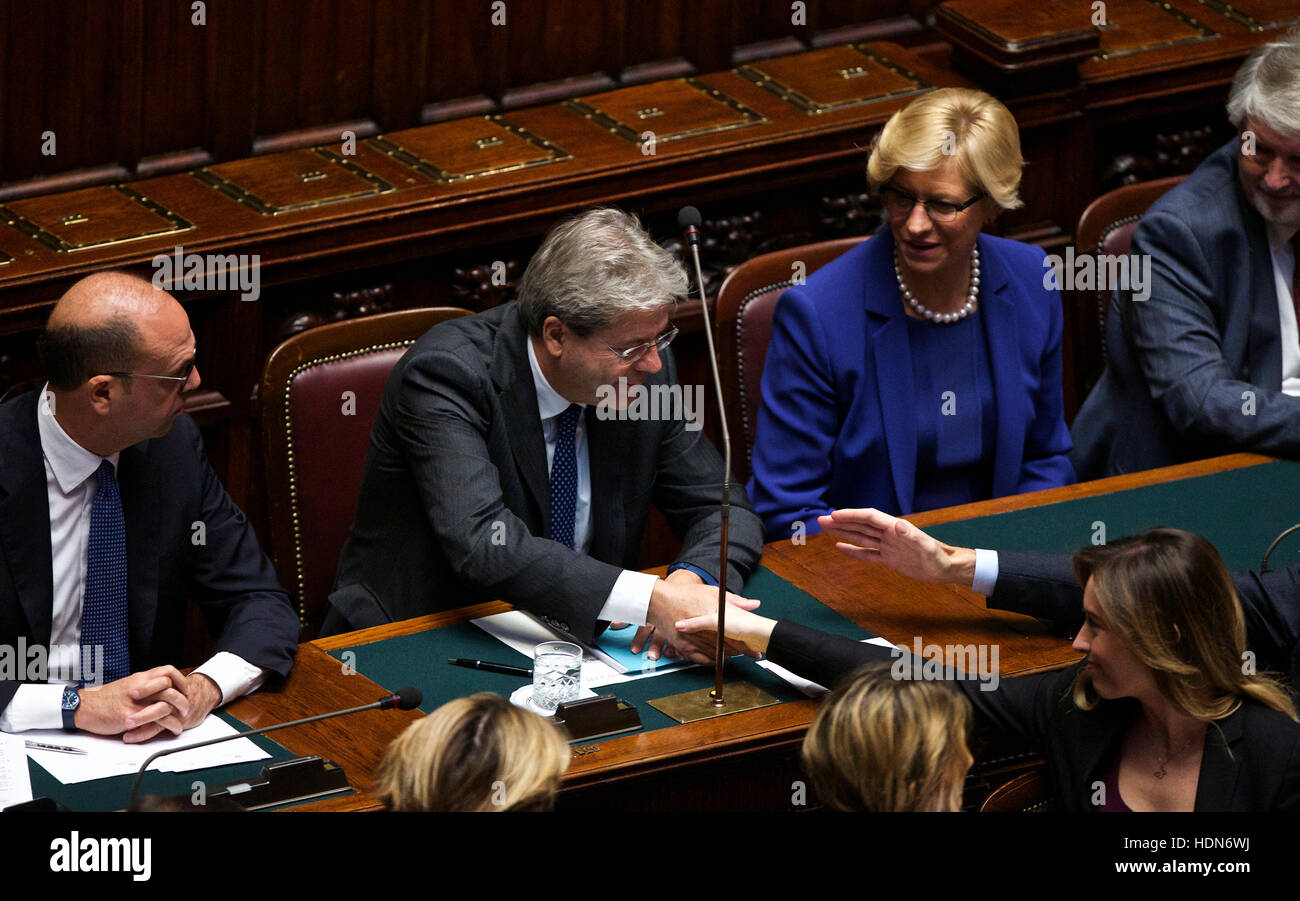 Rome, Italy. 13th Dec, 2016. Italian Prime Minister Paolo Gentiloni (2nd L, Rear) is greeted by ministers in the Lower House ahead of a confidence vote in Rome, capital of Italy, on Dec. 13, 2016. The new government of Italian Prime Minister Paolo Gentiloni cleared a Lower House confidence vote on Tuesday with 368 in favor and 105 against. Credit:  Jin Yu/Xinhua/Alamy Live News Stock Photo