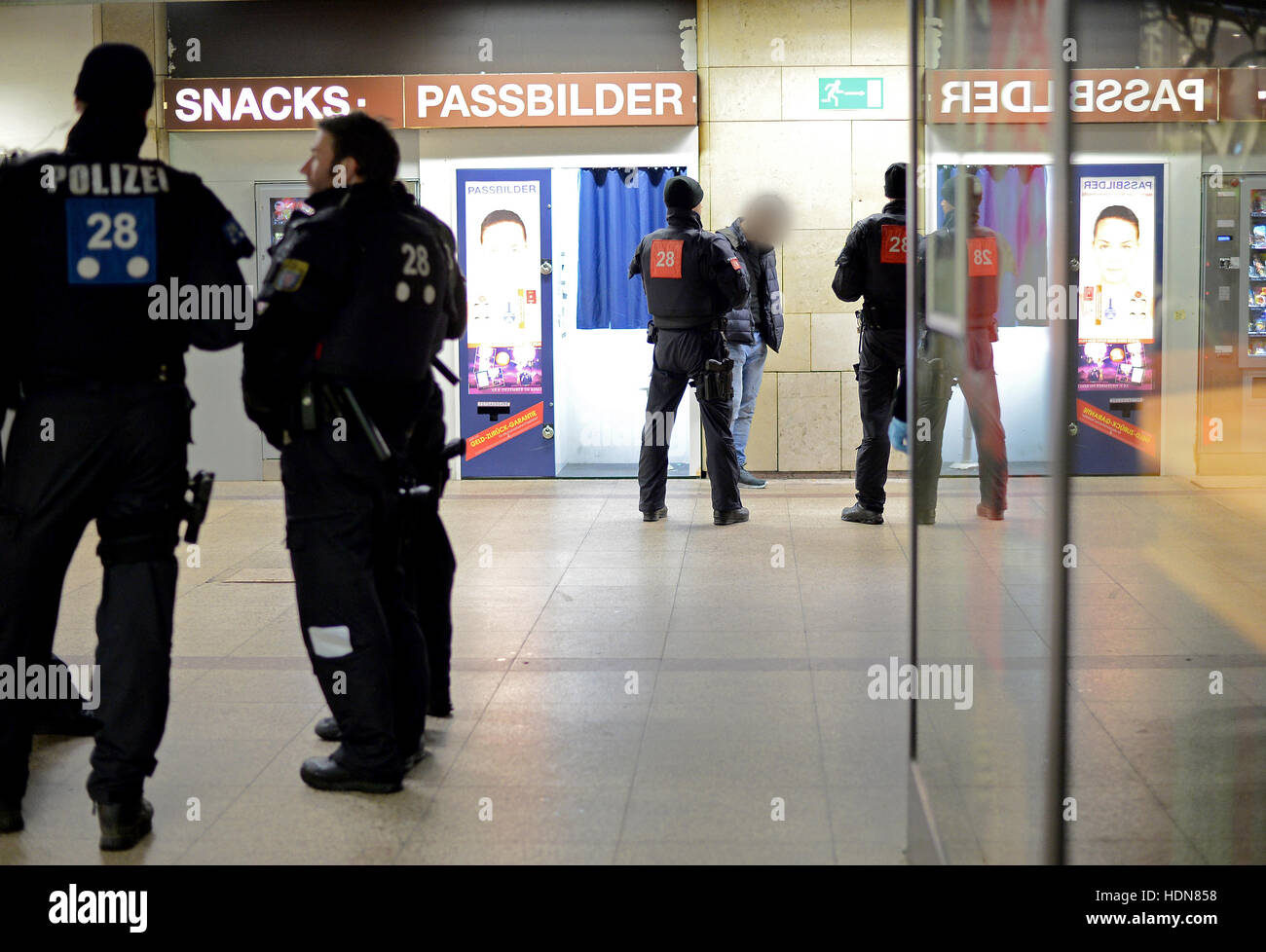 Police officers search a suspect in Frankfurt Central Station, Frankfurt am Main, Germany, 13 December 2016. The police has stepped up its patrols in the station in order to prevent crime and the drug trade. - ATTENTION EDITORS: The face of the suspect has been pixelated in order to preserve his/her anonymity - Photo: Boris Roessler/dpa Stock Photo