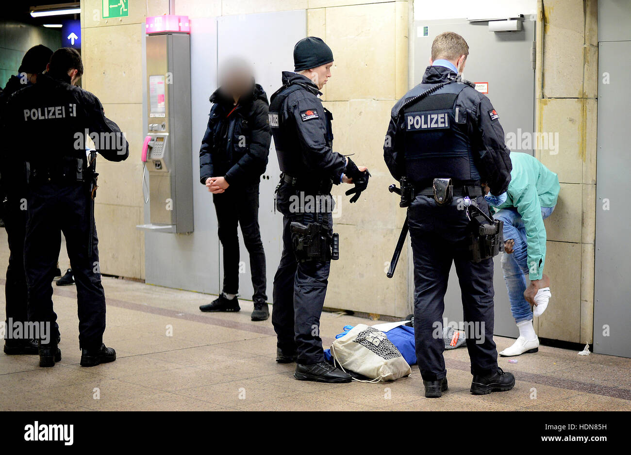 Police officers search a suspect in Frankfurt Central Station, Frankfurt am Main, Germany, 13 December 2016. The police has stepped up its patrols in the station in order to prevent crime and the drug trade. - ATTENTION EDITORS: The face of the suspect has been pixelated in order to preserve his/her anonymity - Photo: Boris Roessler/dpa Stock Photo
