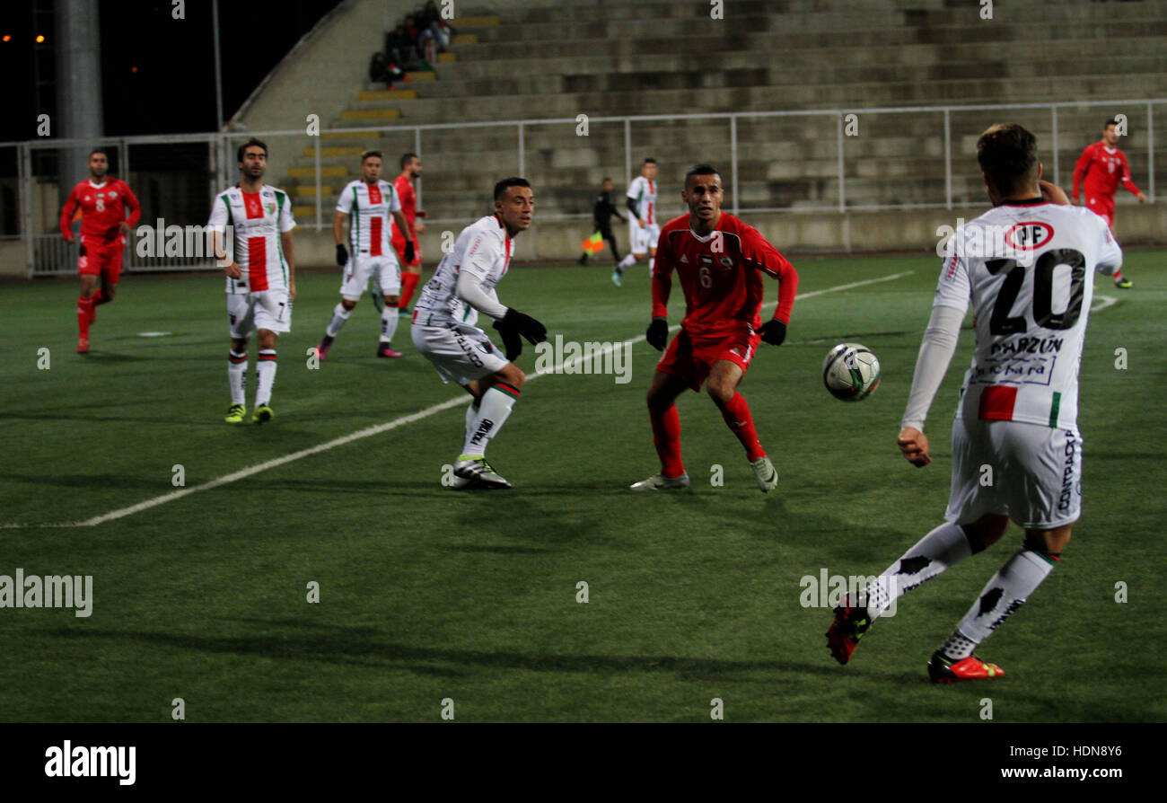 West Bank, West Bank, Palestinian Territory. 13th Dec, 2016. Palestino players and Chile players compete during their friendly soccer match between Palestine and CD Palestino at Nablus Stadium in The West Bank City of Nablus, 13 December 2016. CD Palestino visit West Bank and Gaza for the second time. The club was founded in 1920 by a group of Palestinian immigrants, and plays in the Primera Division of Chile © Nedal Eshtayah/APA Images/ZUMA Wire/Alamy Live News Stock Photo