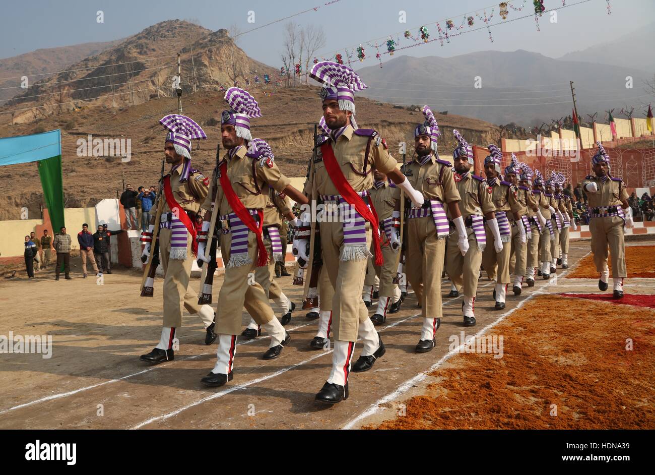 Srinagar, Kashmir. 14th Dec, 2016. Recruits of Indian police march during a passing out parade at a training center in Pulwama district, about 20 km south of Srinagar, summer capital of Kashmir, Dec. 14, 2016. A total of 355 recruits were formally inducted into the Indian police after completing nine months of training in physical fitness, weapon handling, commando operations and counter insurgency, a police spokesman said. Credit:  Javed Dar/Xinhua/Alamy Live News Stock Photo