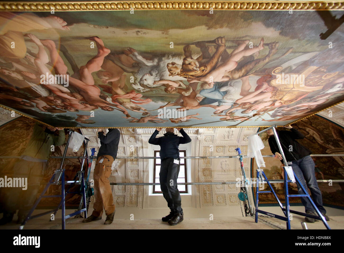 Woerlitz, Germany. 14th Dec, 2016. Conservators mount the freshly restored ceiling fresco from the 17th Century in the ballroom of the Palace Woerlitz in Woerlitz, Germany, 14 December 2016. The more than ten square metres large painting depicts the triumph of the God of Wine Bacchus and was taken down for restoration in May of this year. Palace Woerlitz is being ongoingly restored on a larger scale since 2000. Photo: Jan Woitas/dpa-Zentralbild/dpa/Alamy Live News Stock Photo