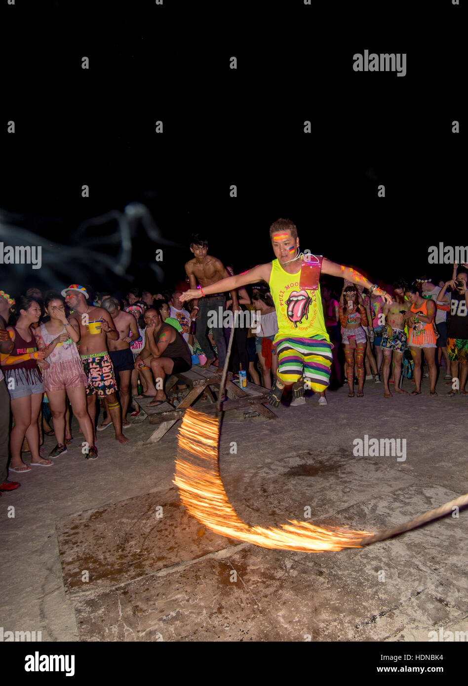 Party Goers Skip With Burning Rope At A Full Moon Party On Sunrise
