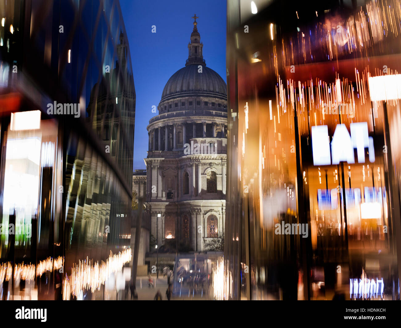 St Paul's Cathedral surrounded by neon shop signs Stock Photo