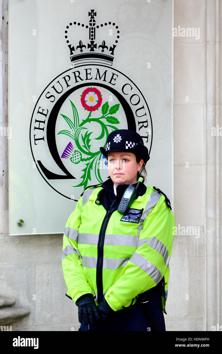 London, England, UK. Female police officer outside the Supreme Court in Parliament Square Stock Photo