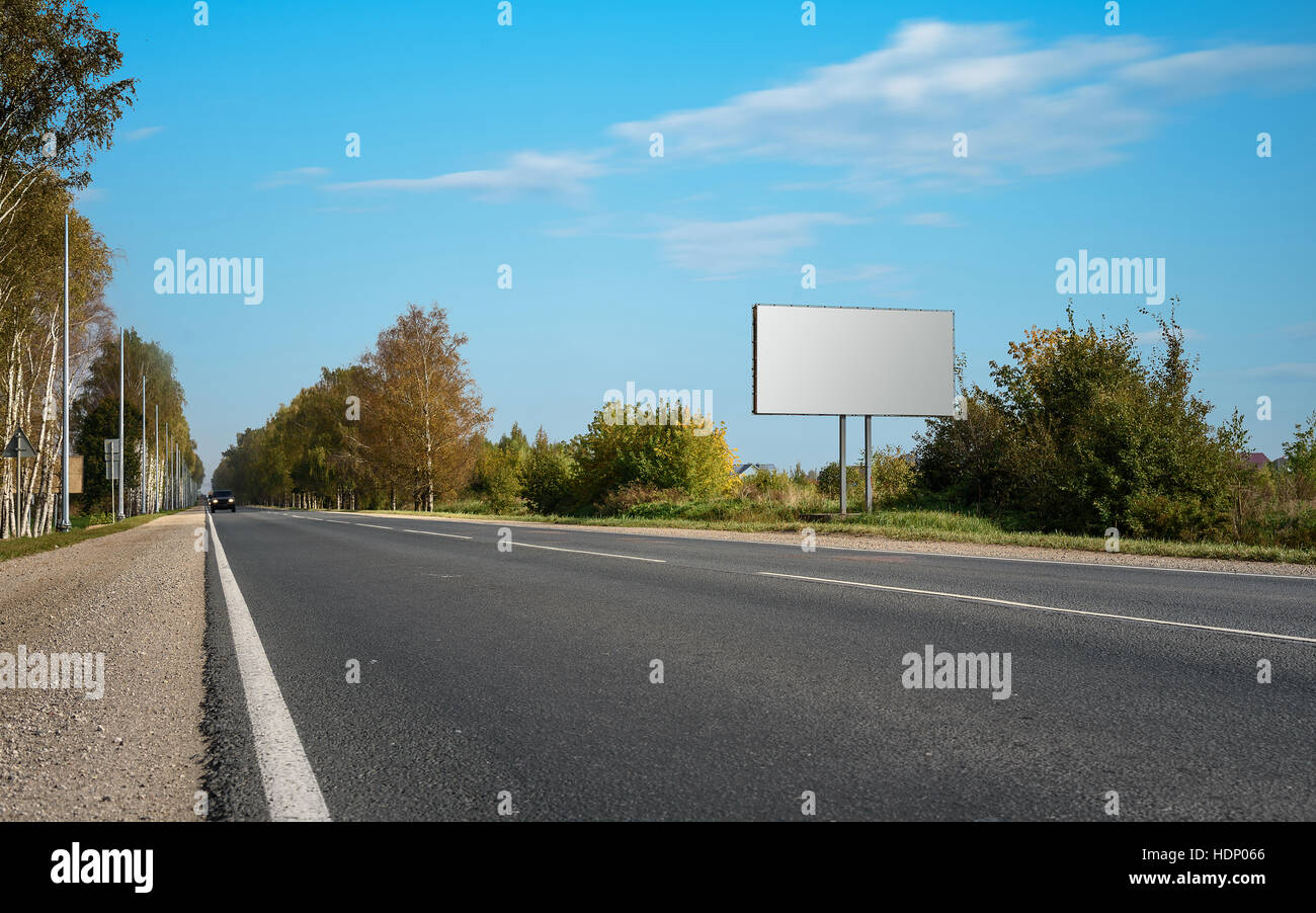Blank billboard on blue sky with the highway Stock Photo
