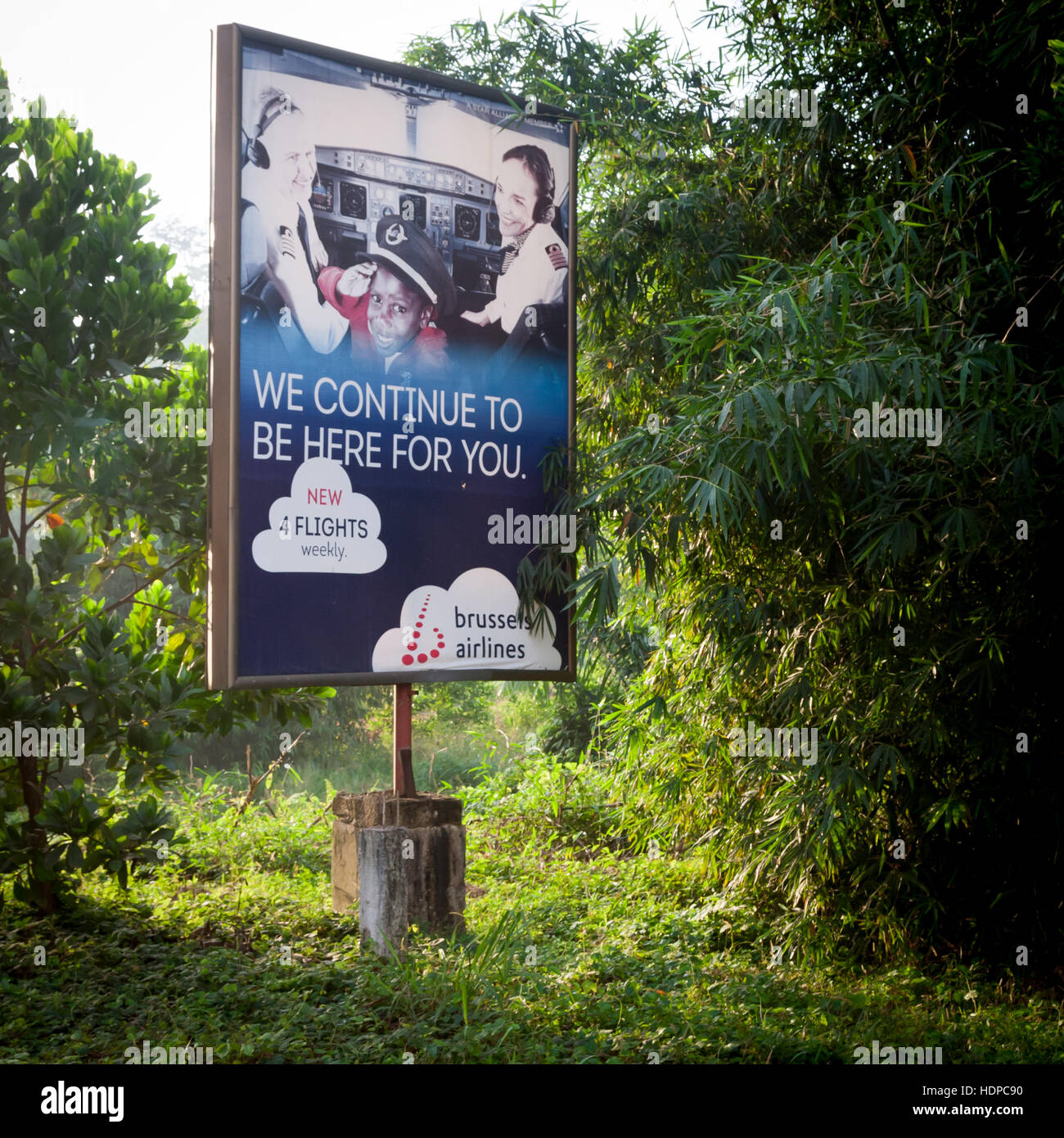 Air connections are a necessary prerequisite for tourism. "We continue to be here for you" Brussels Airways. Billboard advertising one of the weekly two direct flights from Europe to Freetown, Sierra Leone. Stock Photo