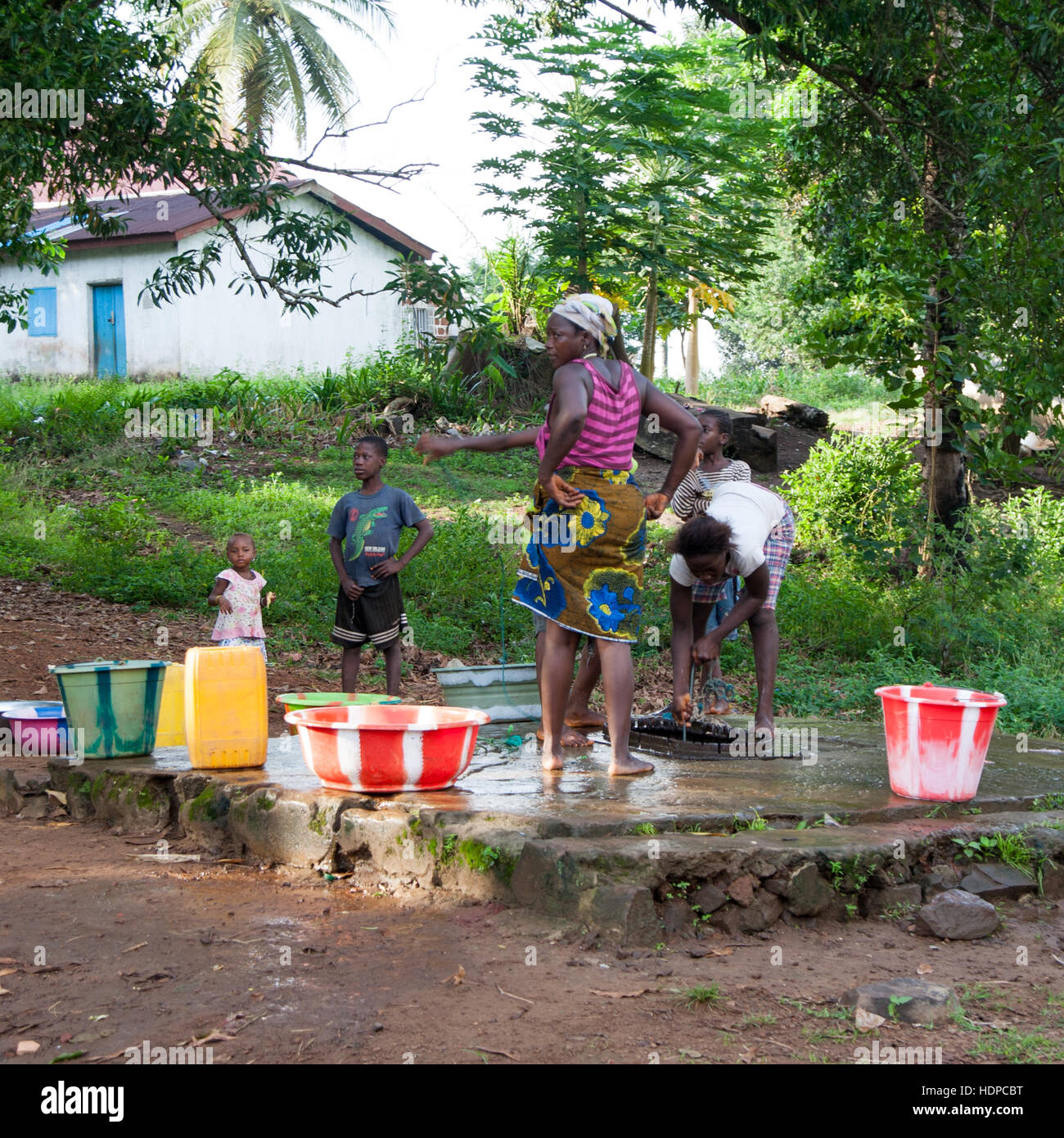 People from village collecting water from community well in Sierra Leone Stock Photo