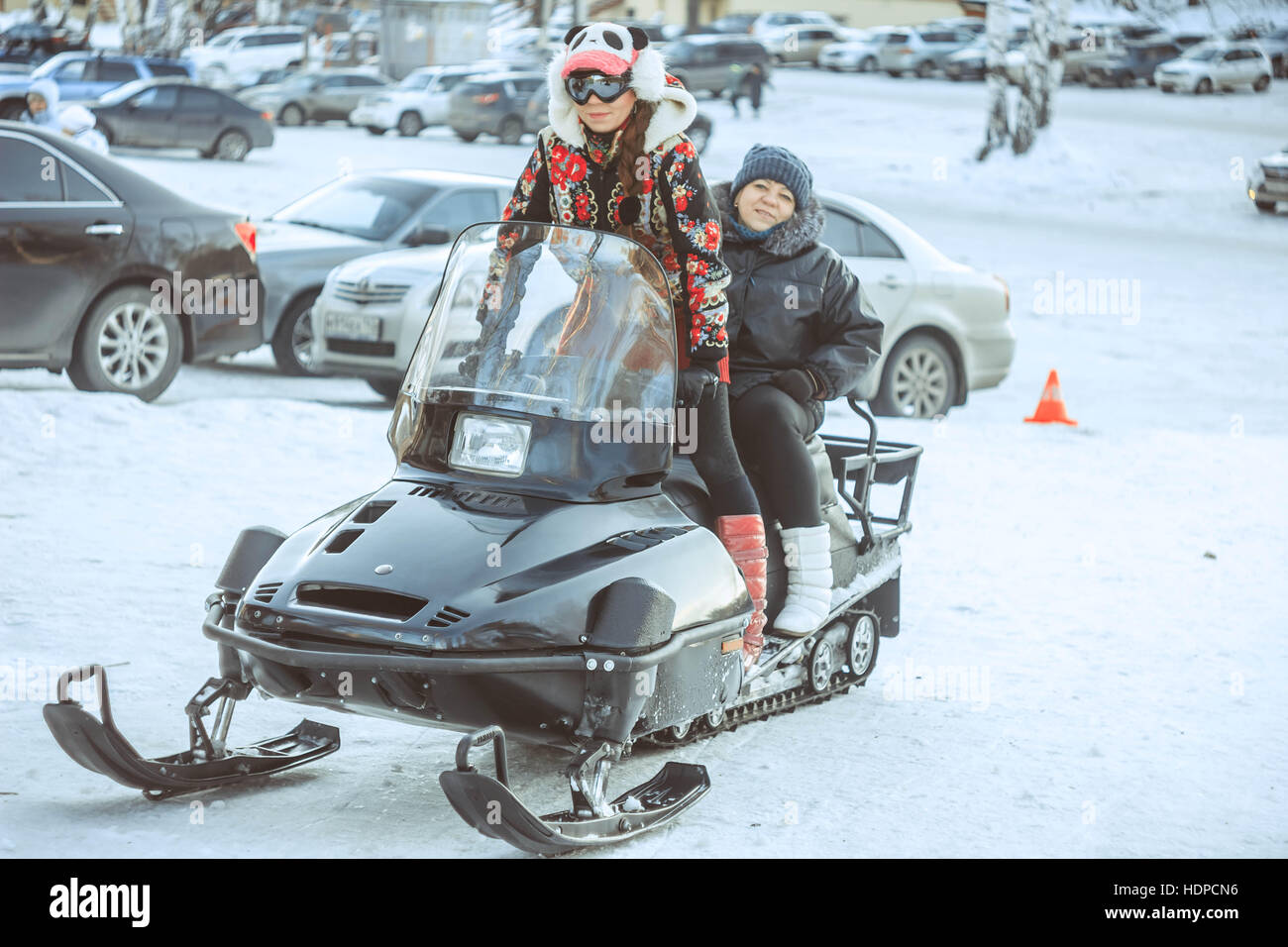 girl sitting on a snowmobile Stock Photo Alamy