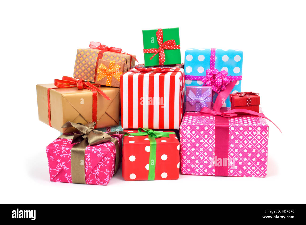 closeup of a pile of gifts wrapped in nice papers and tied with ribbons of different colors on a white background Stock Photo