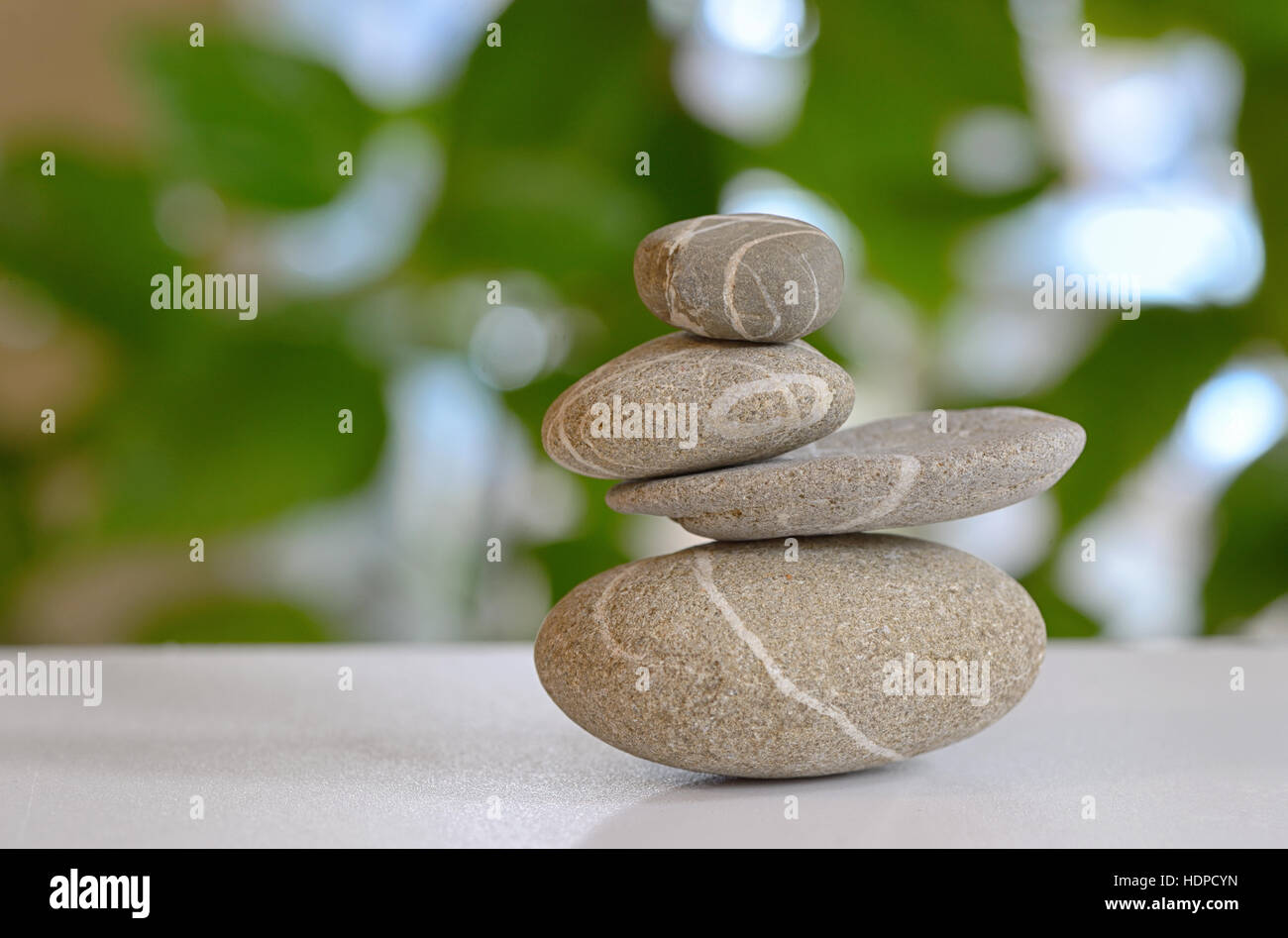 pebble stones pyramid with nature in background Stock Photo