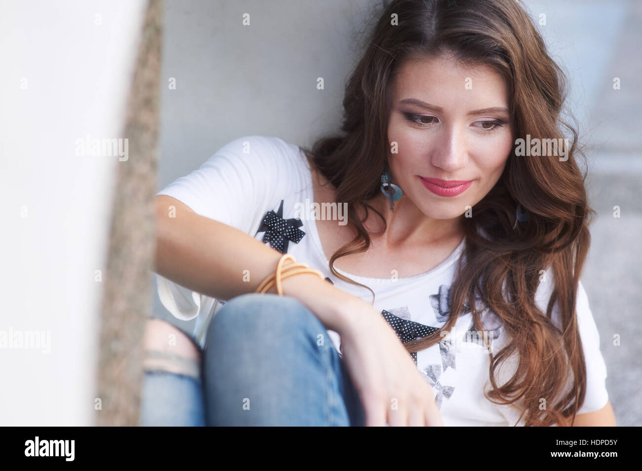 beautiful young woman sitting in the summer Park Stock Photo - Alamy