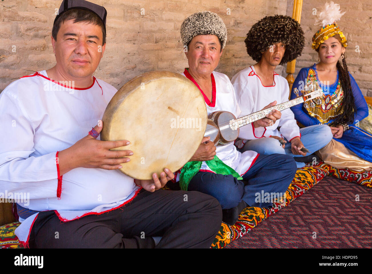 Khorezmian musicians in traditional dresses playing and singing  local songs in Khiva, Uzbekistan Stock Photo
