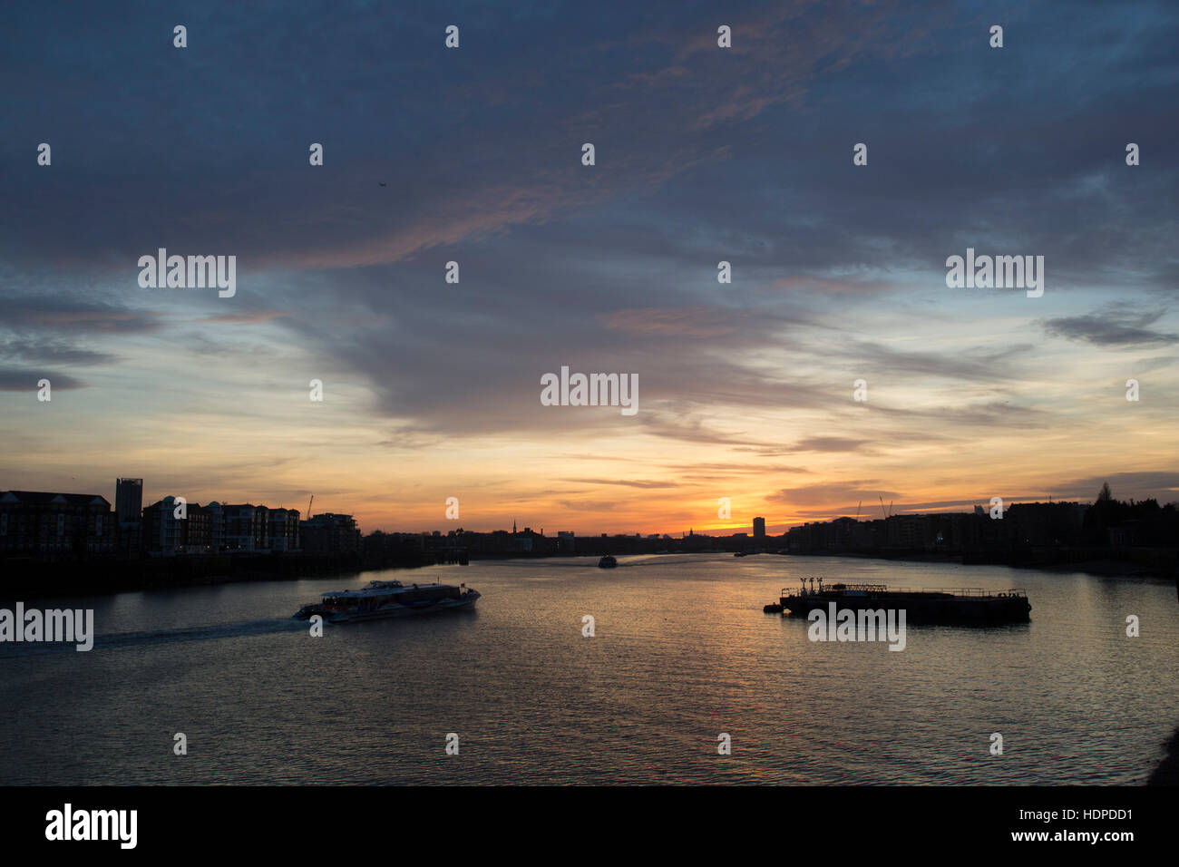 Golden sky at sunset looking over the River Thames at Wapping in East London, England, United Kingdom. Stock Photo