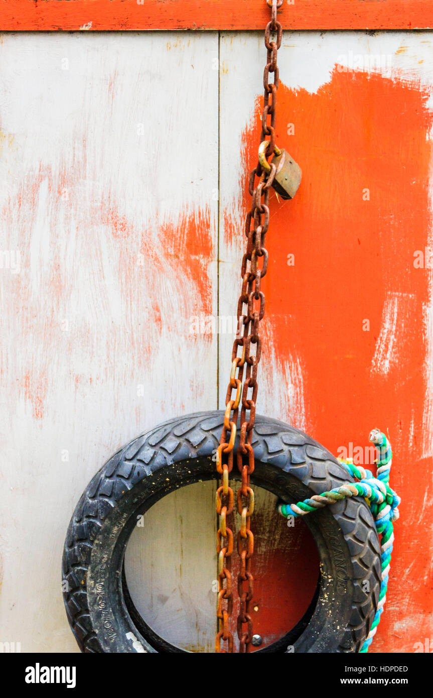 Abstract Image Of A Car Tyre Used As A Fender On A Red And White Stock Photo Alamy