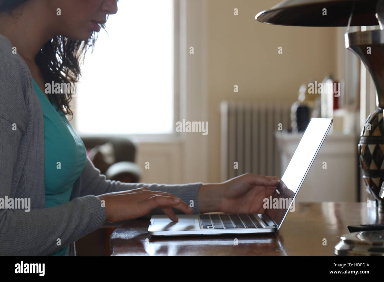 Young woman working from home on laptop at office desk Stock Photo - Alamy