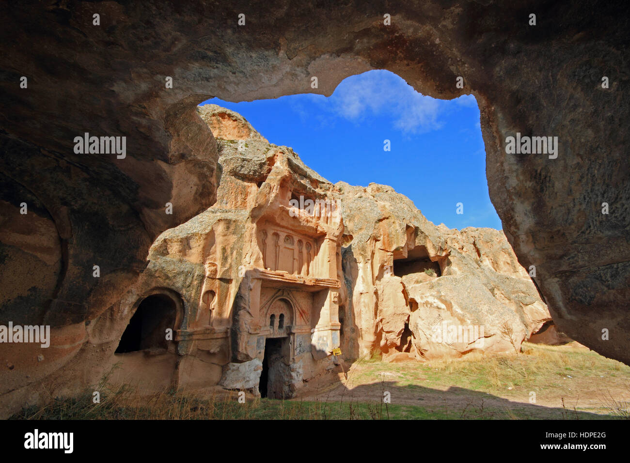 Old monastery carved out of the rock, in historical site known as Open Palace or Acik Saray in Cappadocia, Turkey. Stock Photo