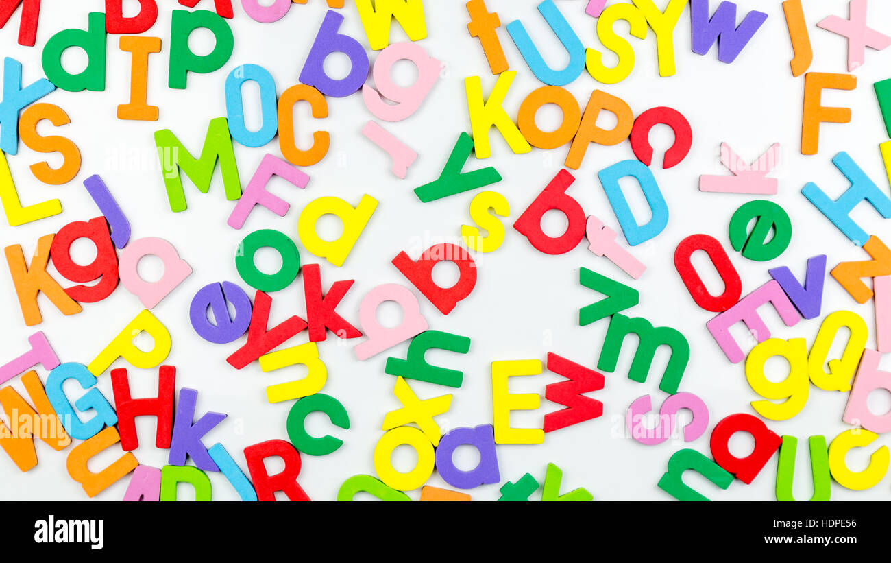 Jumbled magbetic alphabet characters on whiteboard Stock Photo
