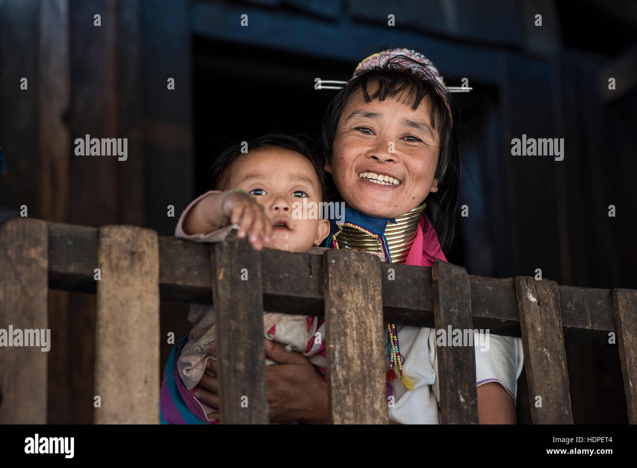 Portrait of a Kayan woman carrying her baby, Loikaw, Kayah State, Myanmar. Stock Photo