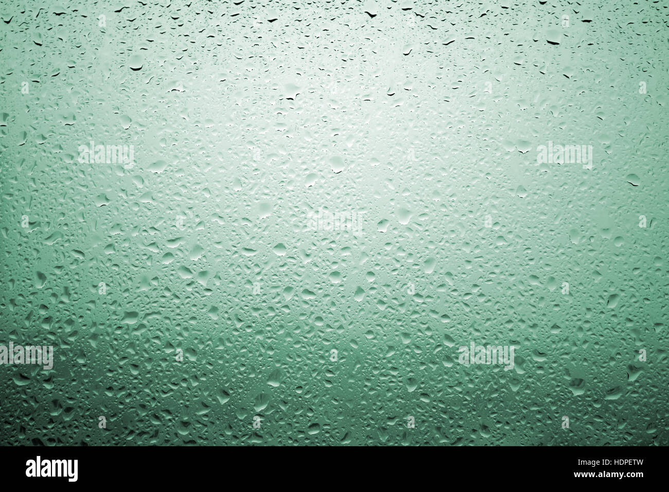 Diffuse Landscape Drops of rain on a window glass with very diffuse landscape bluish ...