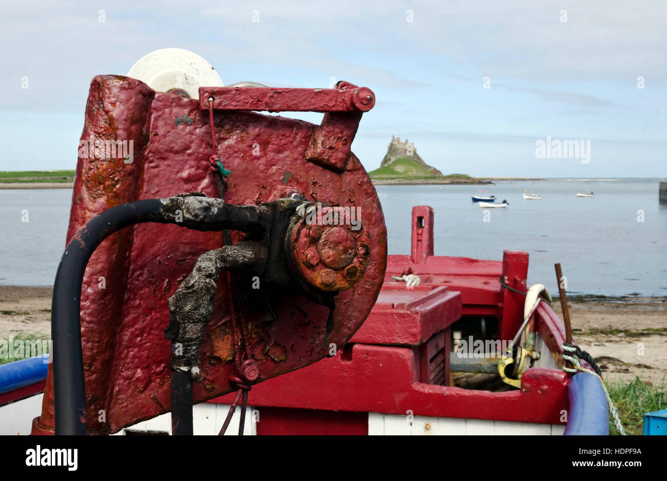 Rusty hydraulic winch on a boat near Lindisfarne (Holy Island) harbour in Northumberland, England. Stock Photo