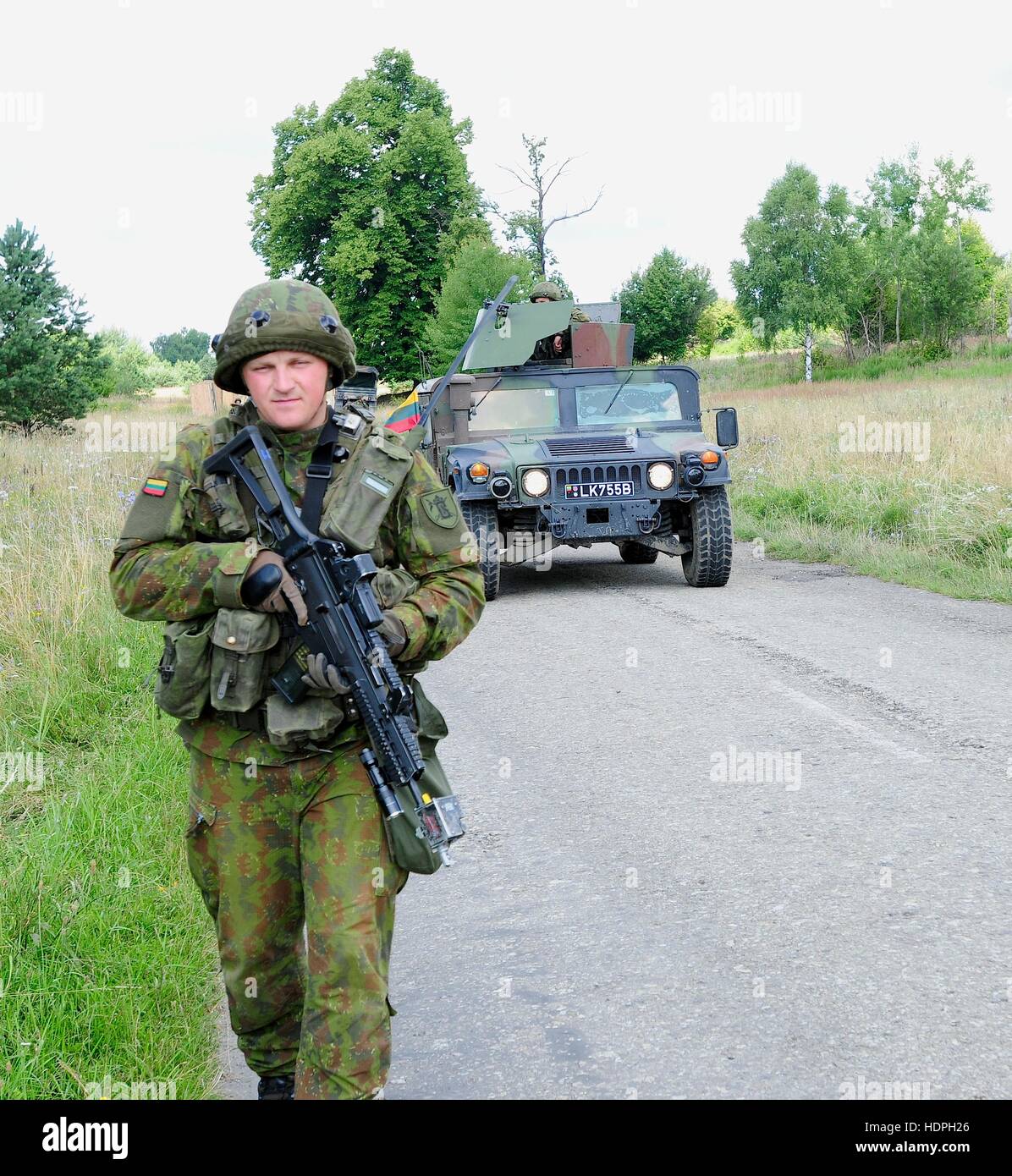 A Lithuanian soldier leads a Humvee on foot during a Rapid Trident situational training exercise at the International Peacekeeping and Security Center July 25, 2015 in Yavoriv, Ukraine. Stock Photo
