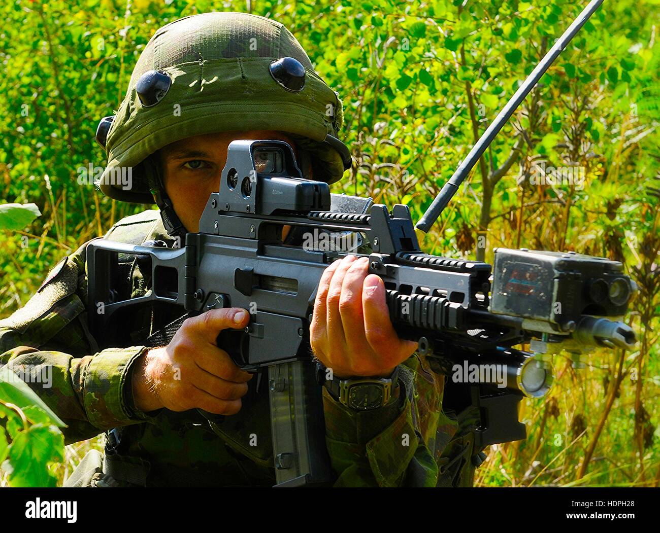 A Lithuanian soldier watches for enemy movement during a Rapid Trident simulated ambush exercise at the International Peacekeeping and Security Center July 25, 2015 in Yavoriv, Ukraine. Stock Photo