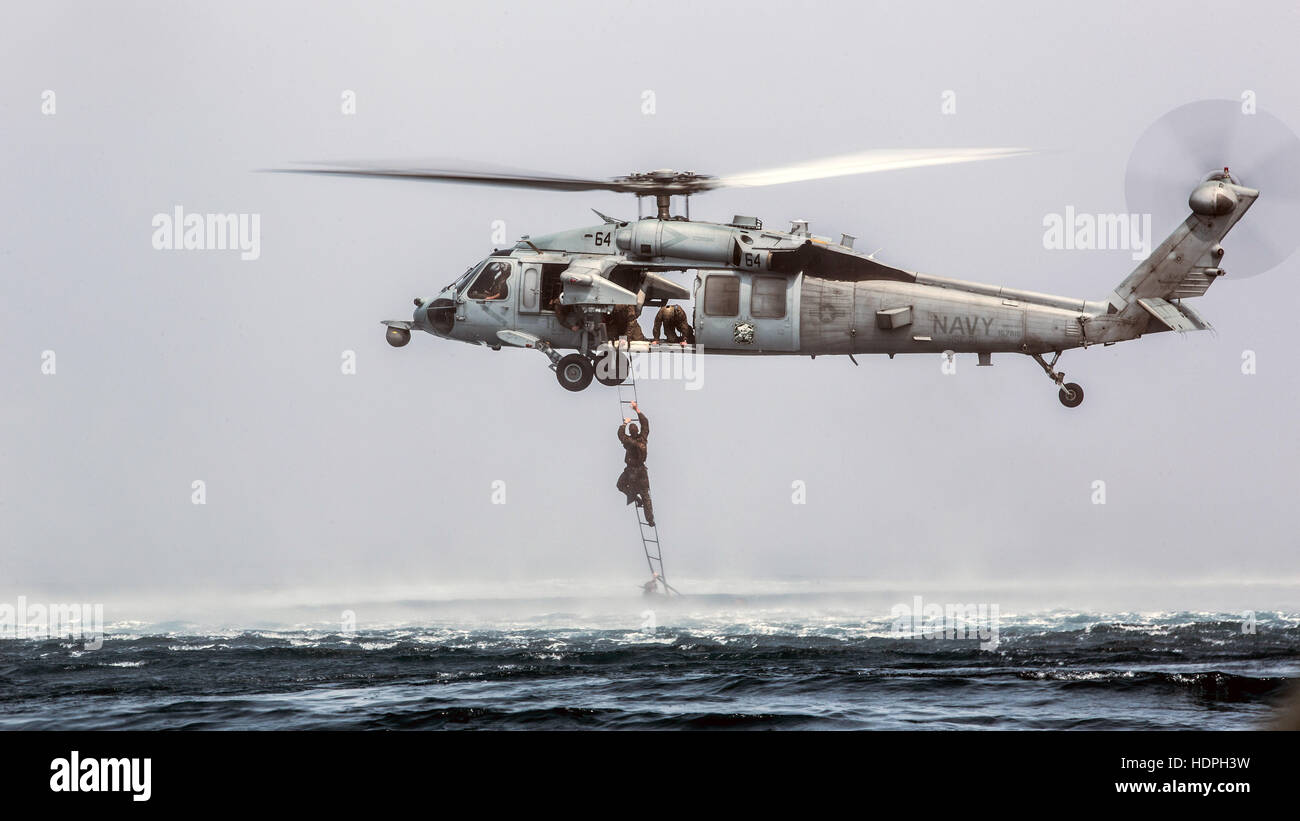 A U.S. Marine special operations soldier climbs a caving ...