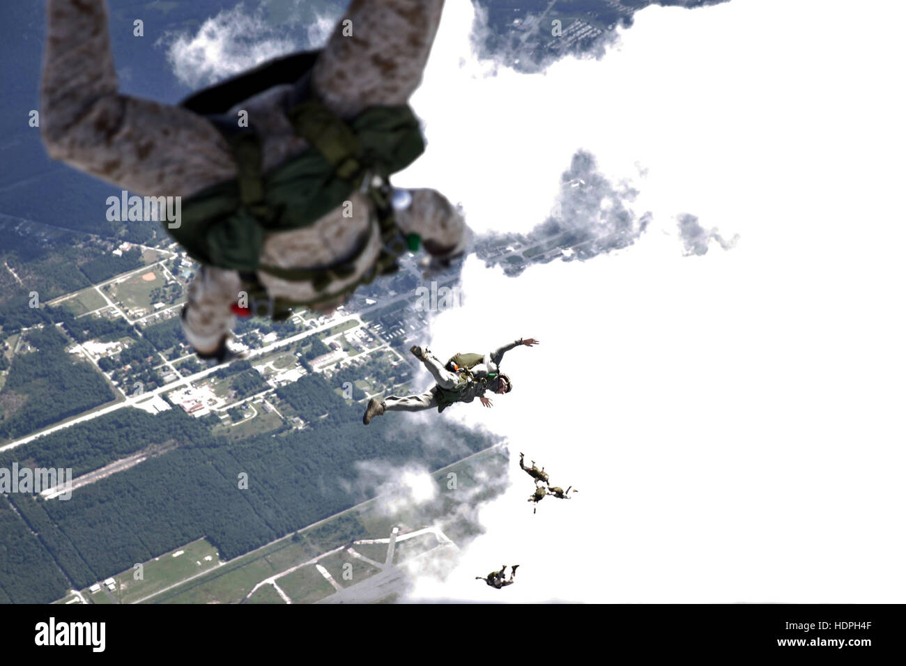 U.S. Marine soldiers conduct a free-fall jump from a Bell Boeing MV-22B Osprey tiltrotor aircraft during parachute exercises above the Marine Corps Base Camp Lejeune Drop Zone Pheasant September 1, 2015 near Jacksonville, North Carolina. Stock Photo