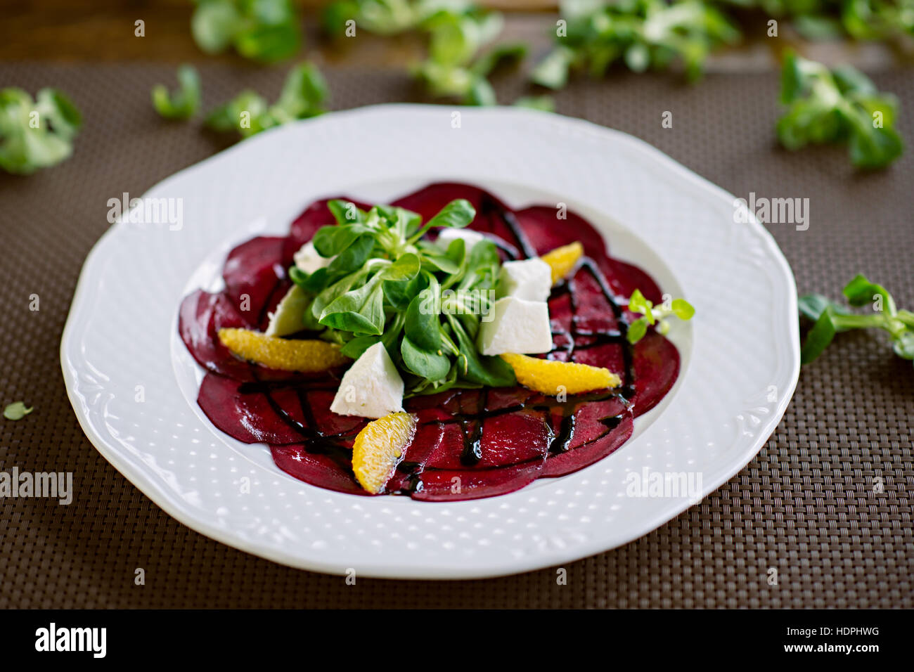 Healthy Vegetarian Salad with Beetroot, Goat Cheese, Orange Slices and Green Salad Served in Restaurant Stock Photo