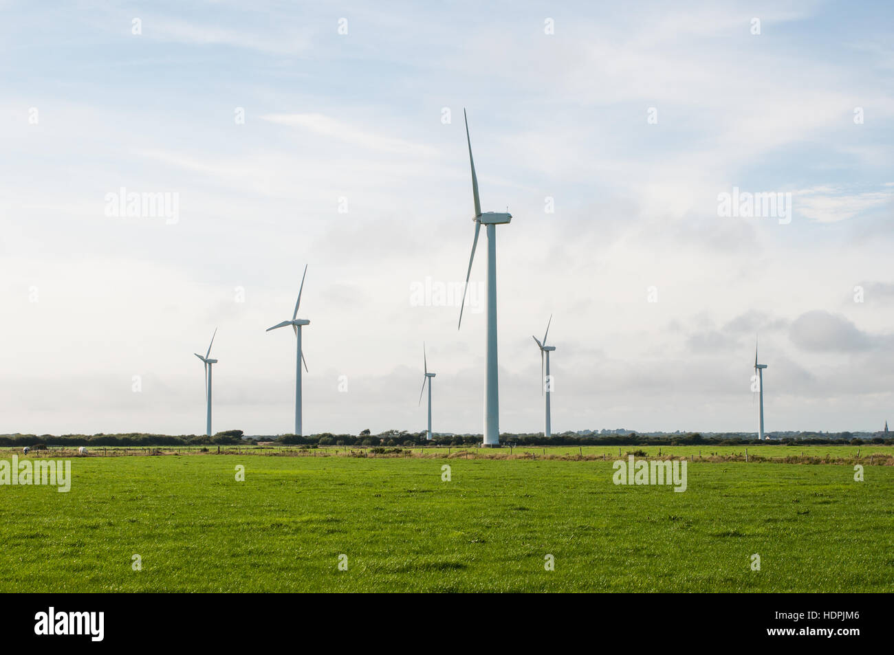 Wind farm turbines on rich green grassland in Wexford in southern Ireland Stock Photo