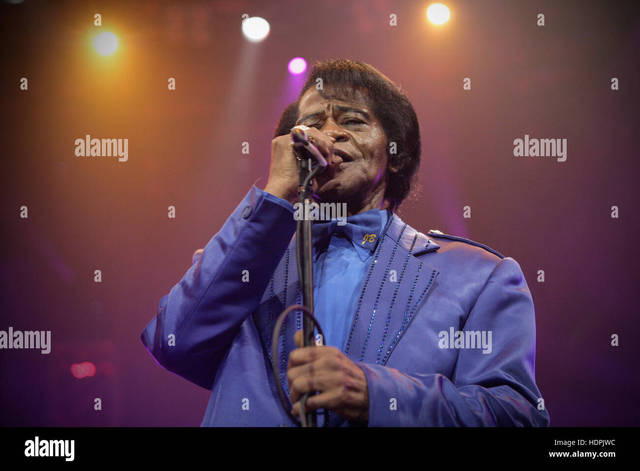 Close up image of James Brown performing on stage with his band in