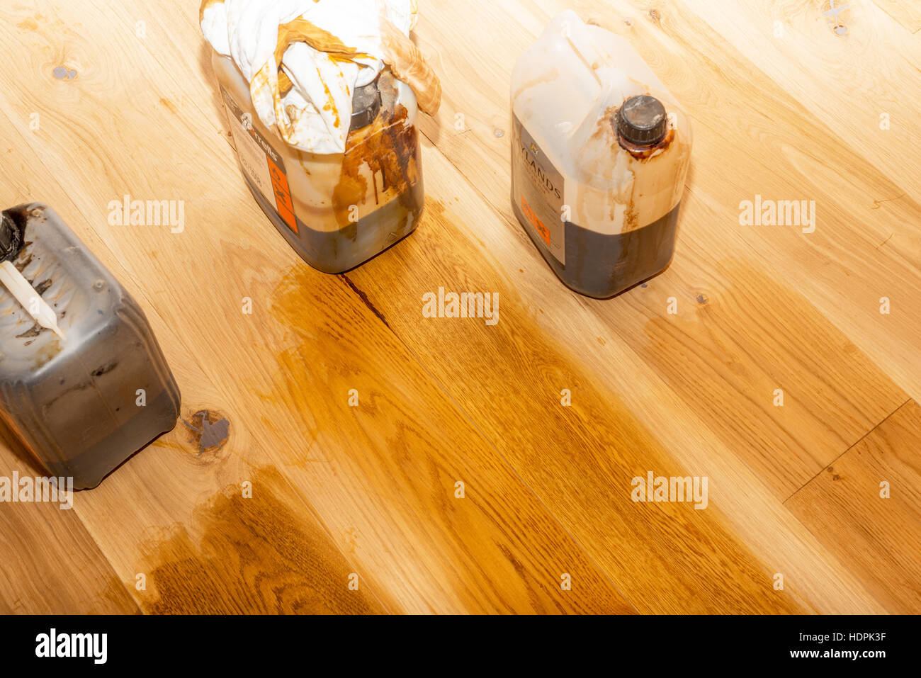 Different shades of woodstain as test patches on an oak wood floor Stock Photo