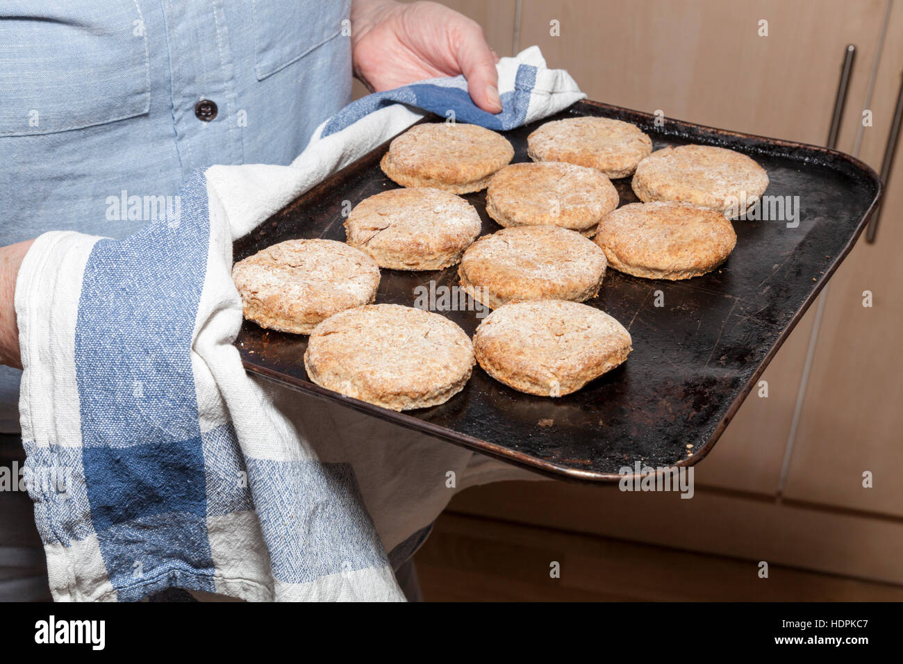 Homemade biscuits or home made cookies on a baking tray just taken from the oven Stock Photo