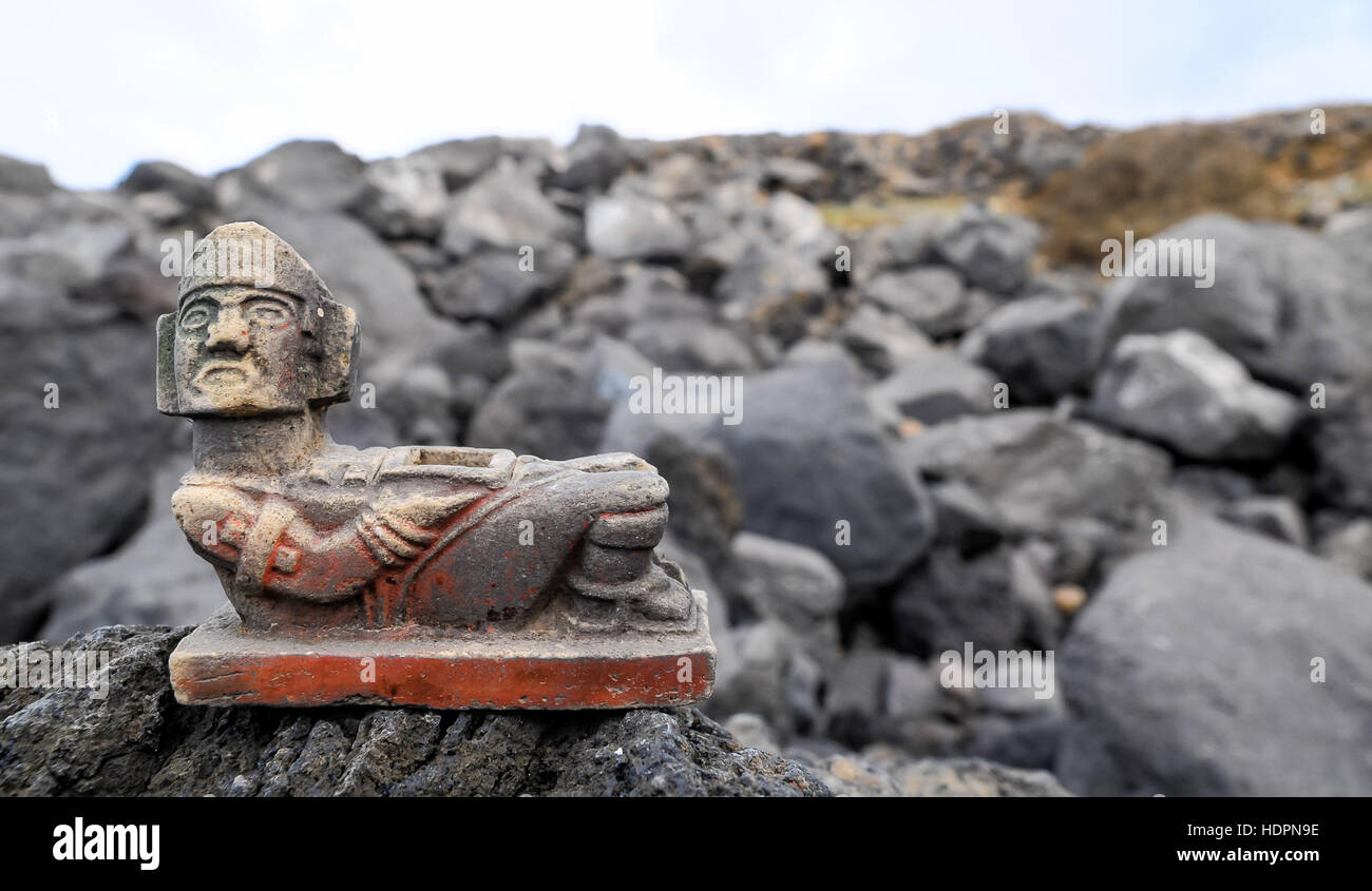 Ancient Maya Statue on the Rocks near Ocean Stock Photo